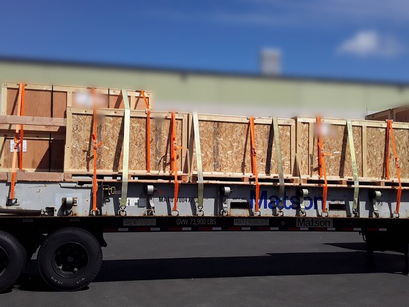 Wooden crates strapped across a flatbed trailer ready to leave.